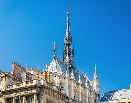 Sainte Chapelle stained glass windows in Paris, showcasing intricate biblical scenes.