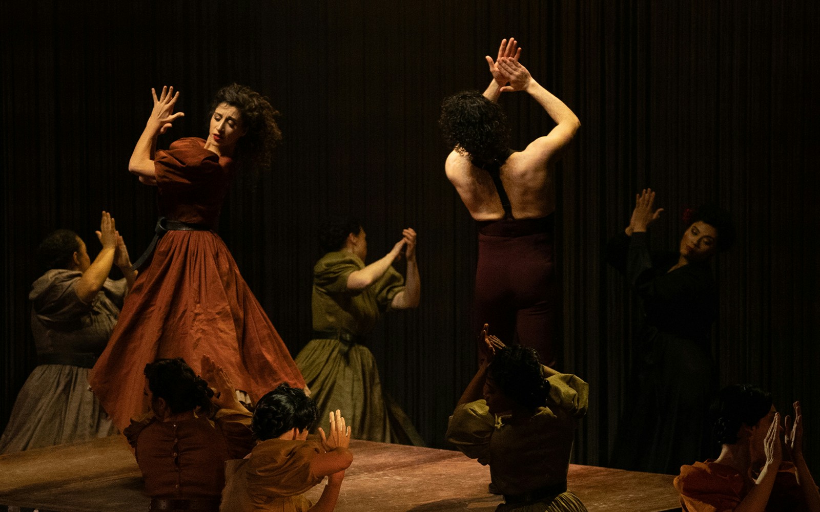 Performers in a dramatic dance scene from Ainadamar production.