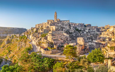 Ancient town of Matera at sunrise, showcasing stone buildings and winding streets, Basilicata, Italy.