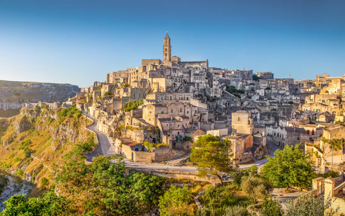 Ancient town of Matera at sunrise, showcasing stone buildings and winding streets, Basilicata, Italy.