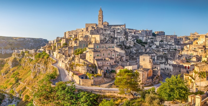 Ancient town of Matera at sunrise, showcasing stone buildings and winding streets, Basilicata, Italy.
