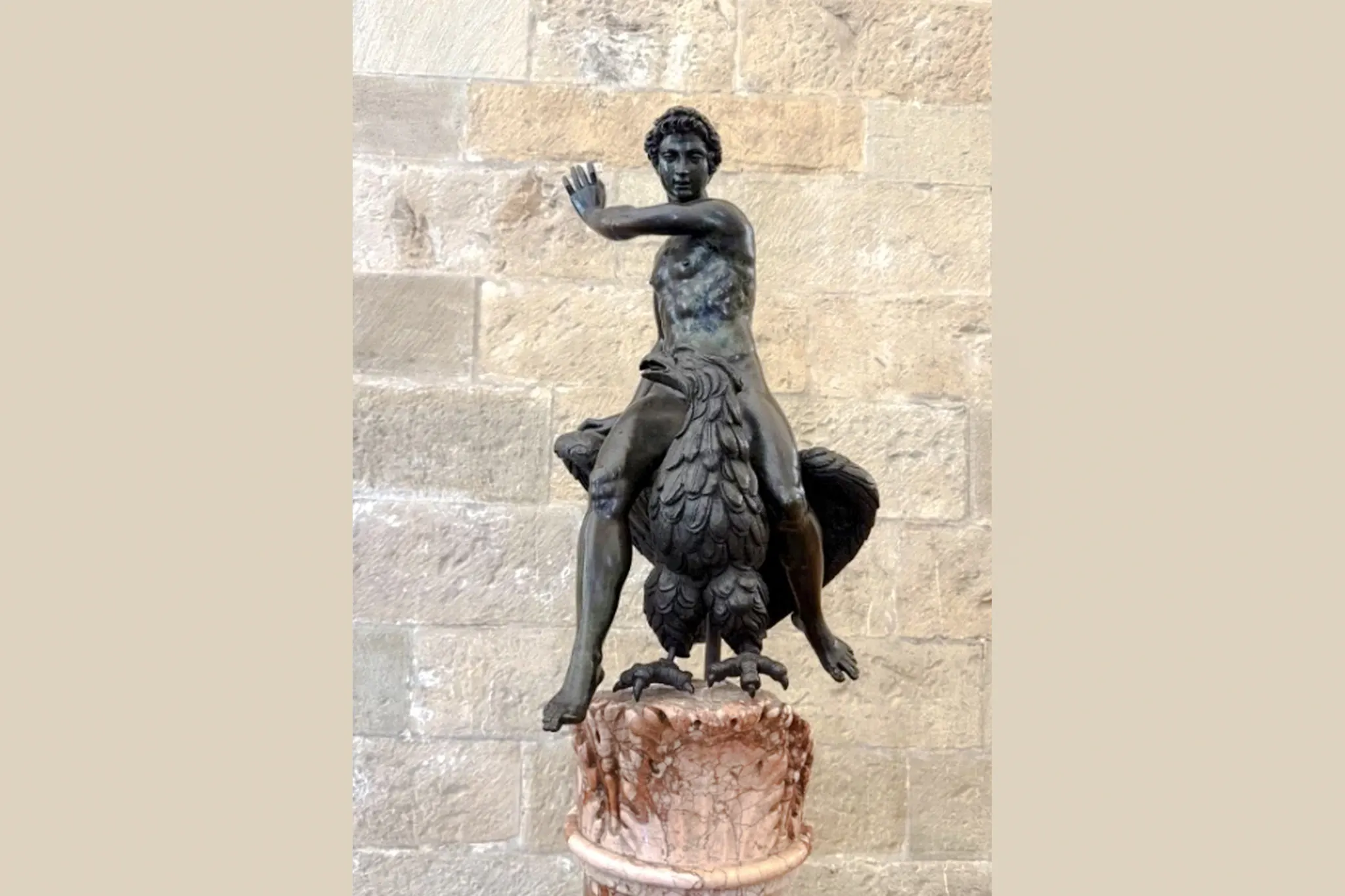 Bronze statue of a man on a bird at Palazzo Vecchio, Florence, related to Medici history.