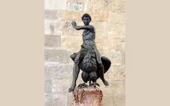 Bronze statue of a man on a bird at Palazzo Vecchio, Florence, related to Medici history.