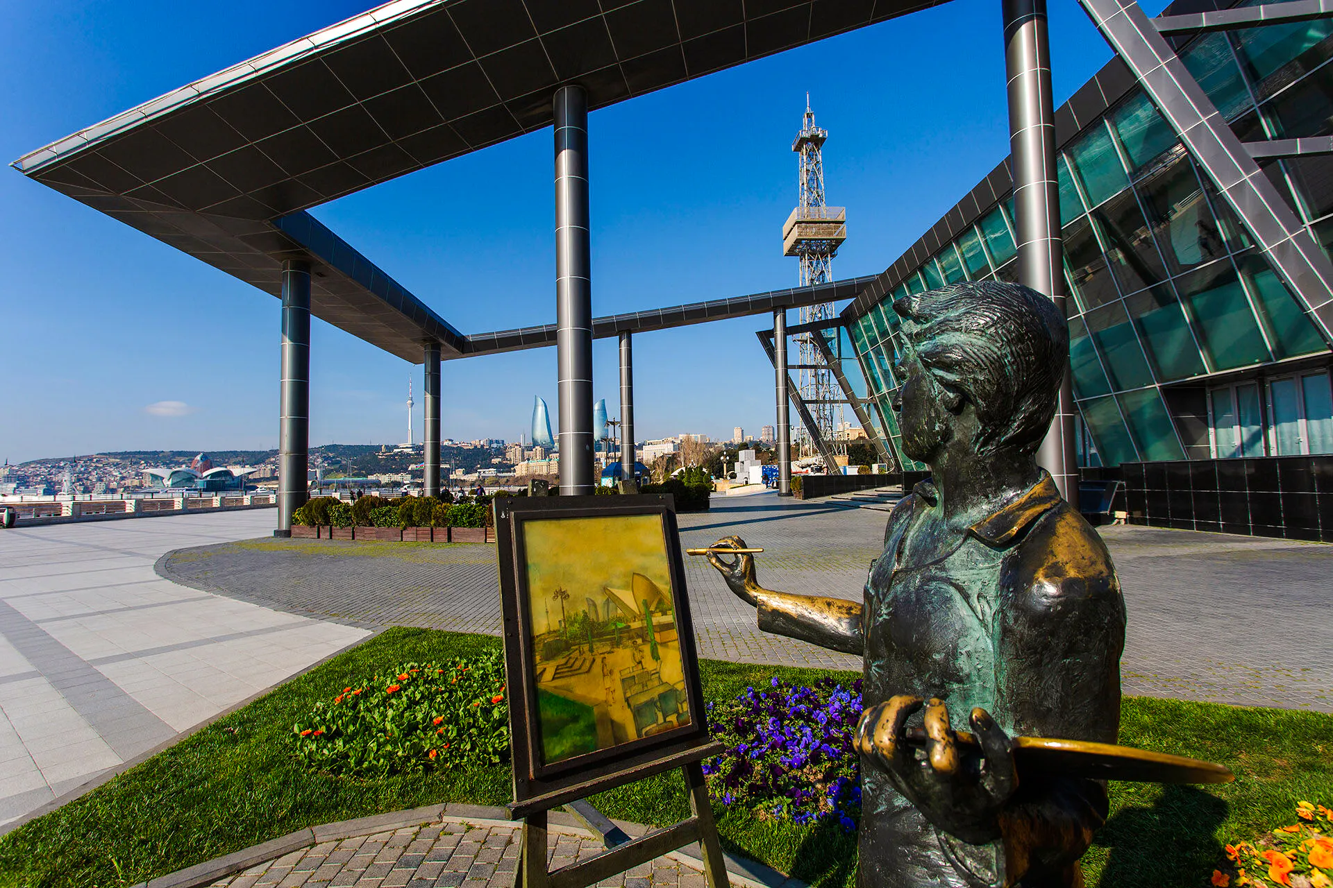 Statue of artist painting Baku skyline with Flame Towers in background, Old and Modern Baku City Tour.