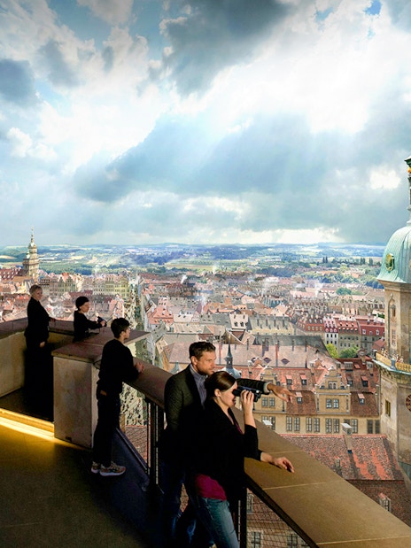 Visitors observing Dresden cityscape from Panometer viewing platform.