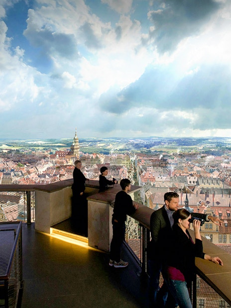 Visitors observing Dresden cityscape from Panometer viewing platform.
