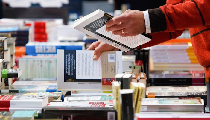 Historic bookshop interior with wooden shelves filled with books in Paris, France.