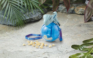 Dinosaur-themed popcorn bucket with popcorn at Universal Studios Japan.