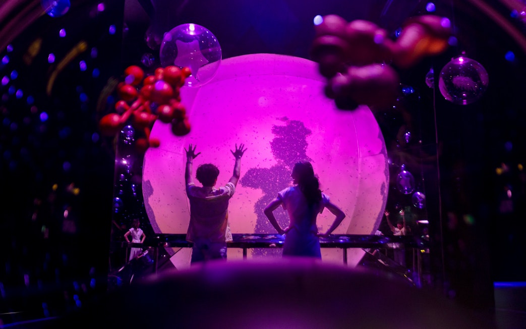 Interactive orb experience at Exploria, Mandai Wildlife, with visitors engaging in a light display.