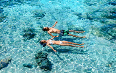 Guests swimming in clear waters at Dolphin Island during Manavgat River cruise.