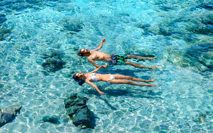 Guests swimming in clear waters at Dolphin Island during Manavgat River cruise.