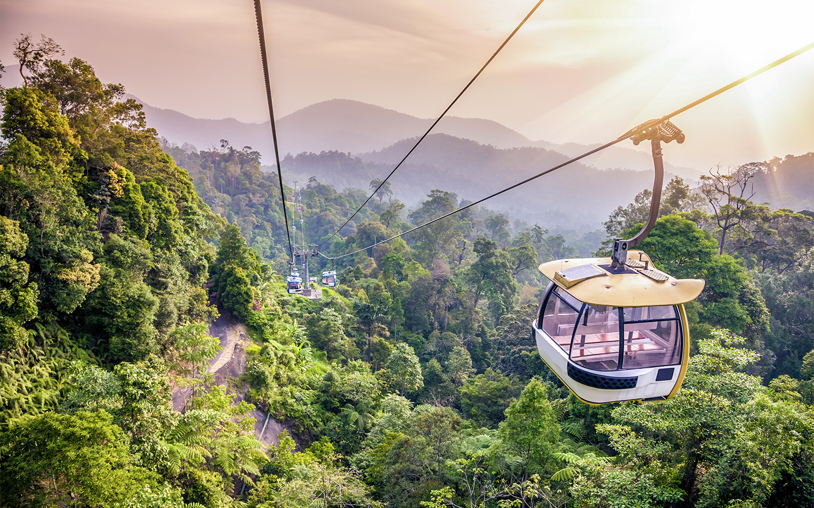 Cable car ride over lush forest in Genting Highlands, Malaysia.
