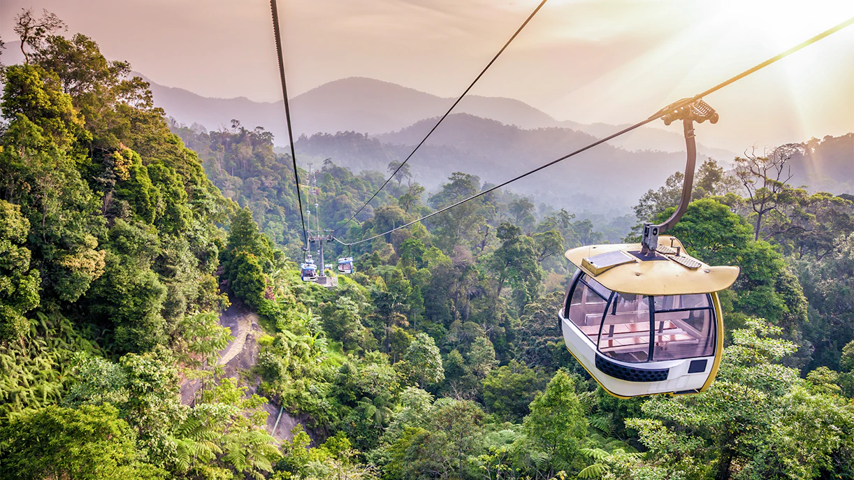 Cable car ride over lush forest in Genting Highlands, Malaysia.