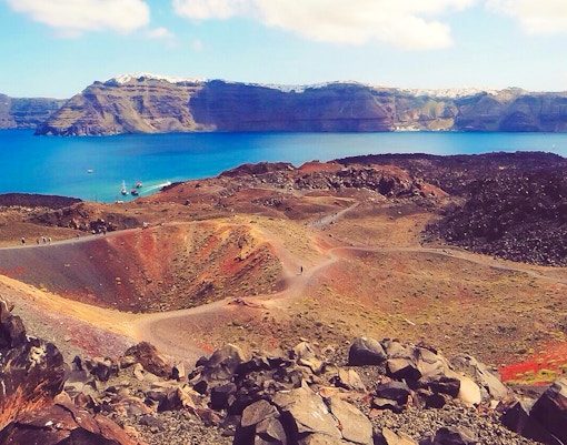 Nea Kameni volcano landscape with walking paths and caldera view in Santorini, Greece.