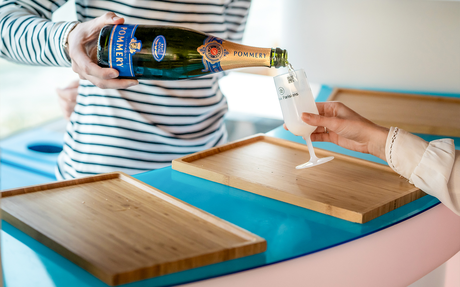 Pouring champagne on Seine River cruise in Paris.