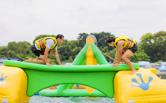 Participants balancing on inflatable obstacle at HydroDash Singapore.