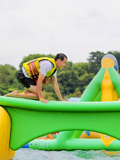 Participants balancing on inflatable obstacle at HydroDash Singapore.