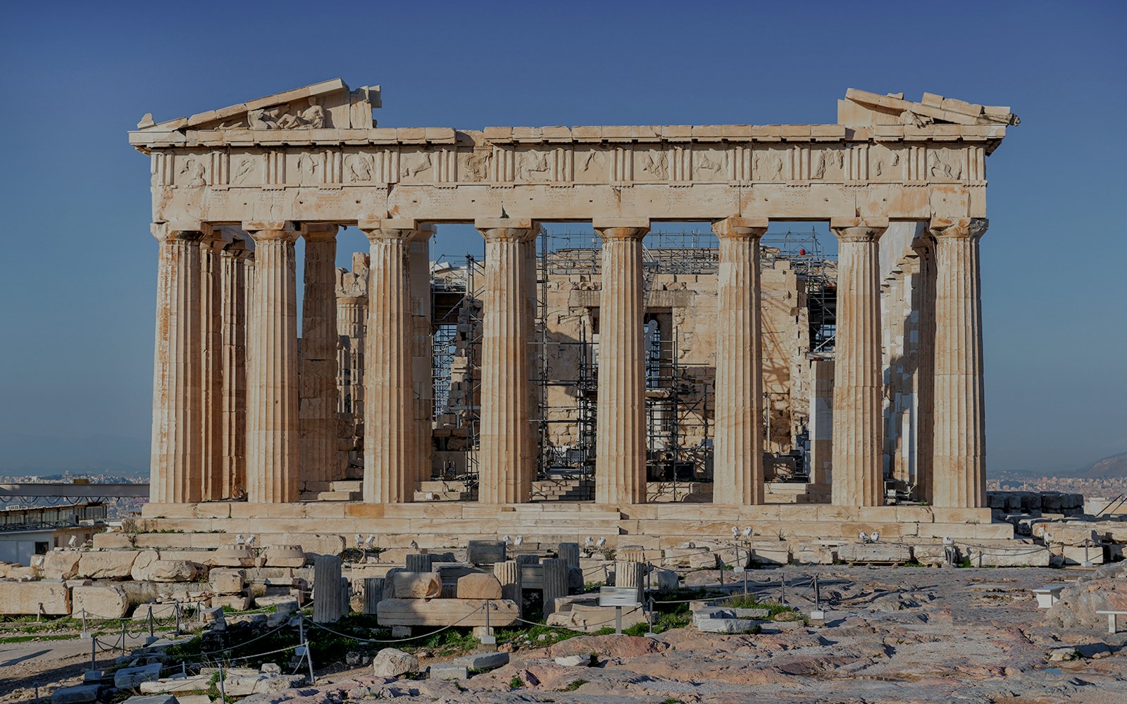 Parthenon Temple atop Acropolis in Athens, Greece, with clear blue sky.