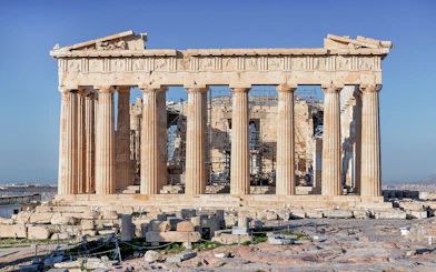 Parthenon Temple on Acropolis hill in Athens, Greece, with clear blue sky.