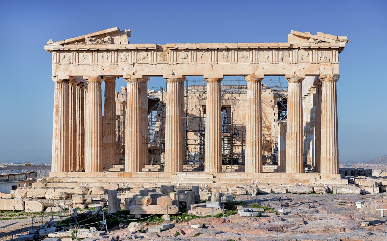 Parthenon Temple on Acropolis hill in Athens, Greece, with clear blue sky.