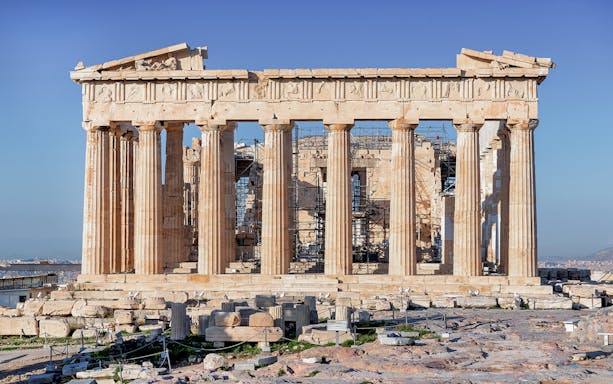 Parthenon Temple on Acropolis hill in Athens, Greece, with clear blue sky.