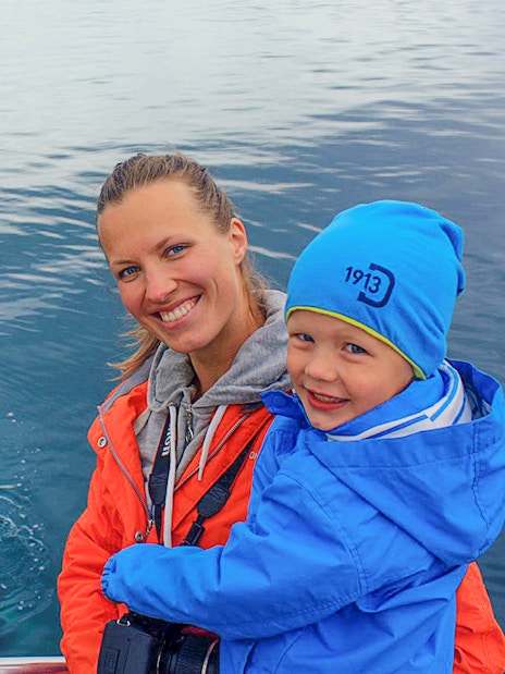 Guests observing a whale in Eyjafjörður, Iceland.