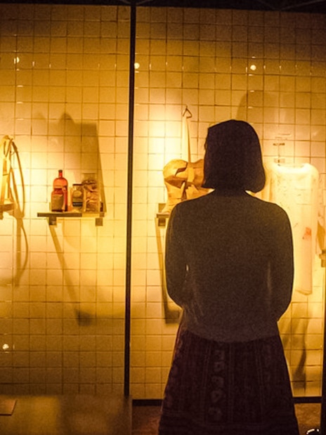 Visitor observing Frida Kahlo's medical artifacts at the Frida Kahlo Museum.