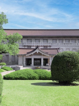 Tokyo National Museum entrance with traditional architecture and manicured gardens.