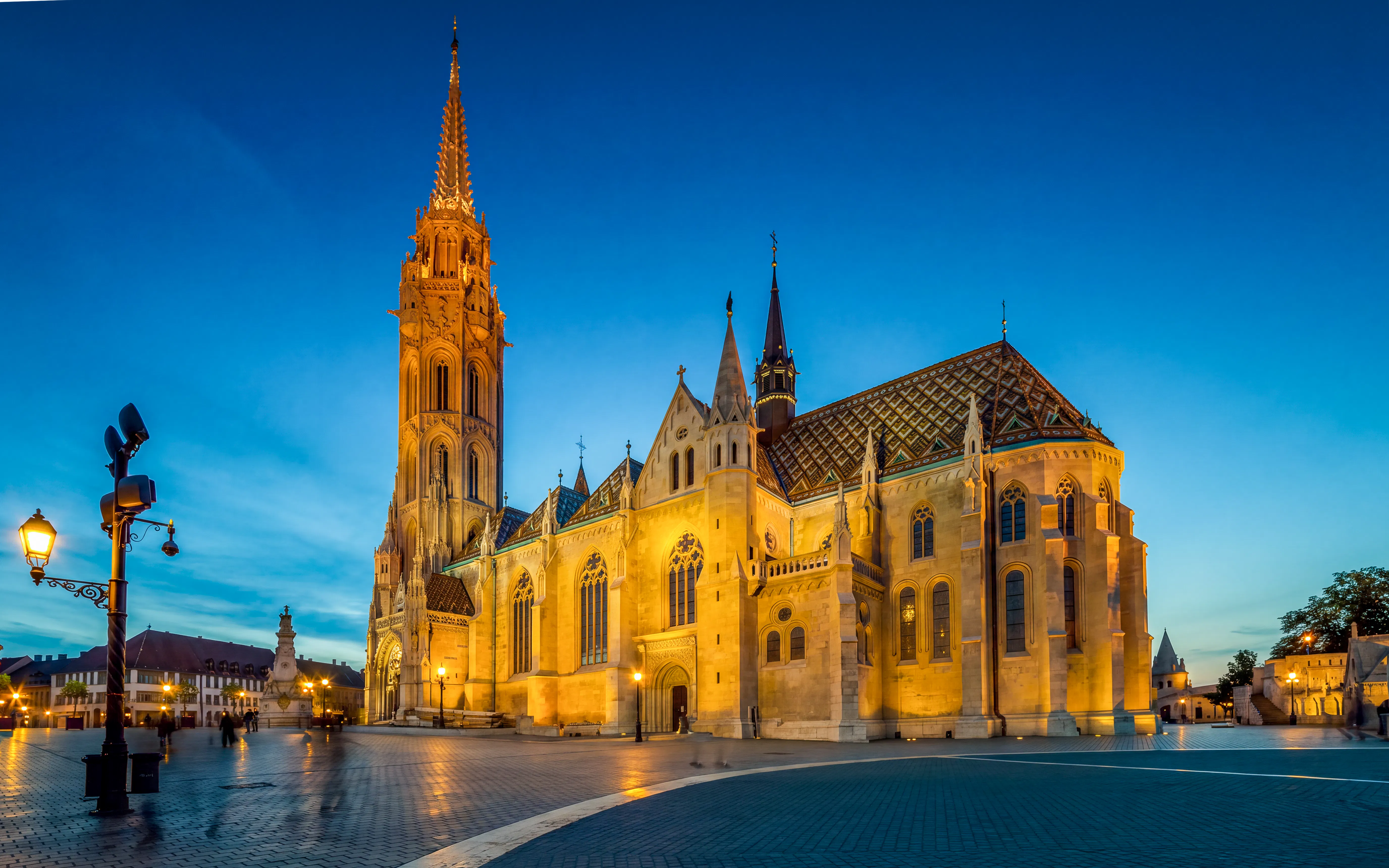 Matthias Church illuminated at night in Budapest, showcasing Gothic architecture.