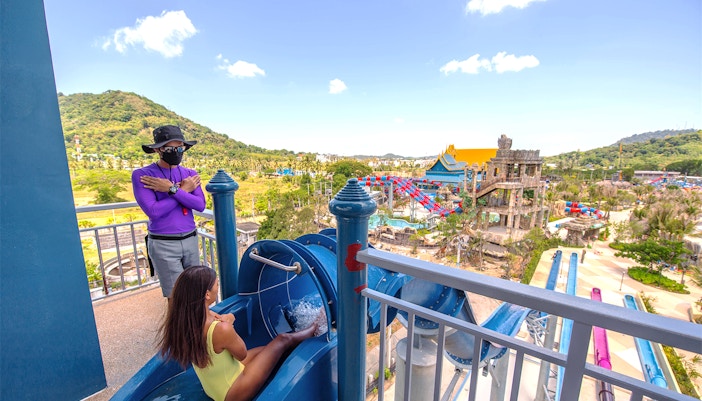 Garuda soars ride at Andamanda Phuket water park, Thailand, with vibrant slides in the background.