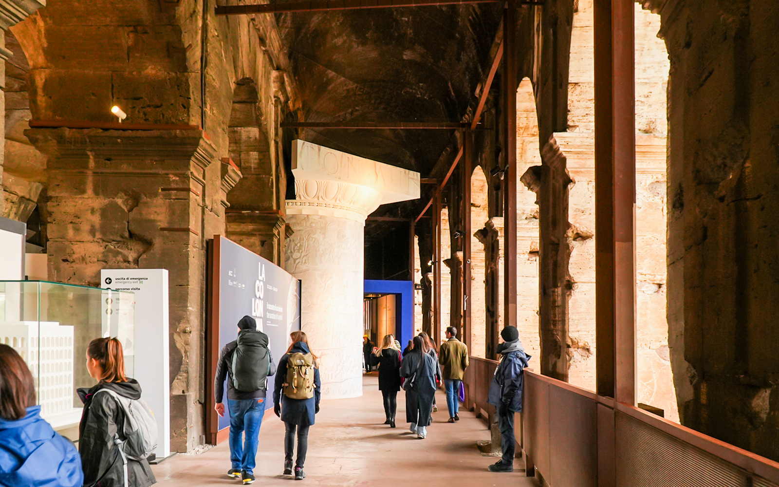 Visitors walking through the Colosseum interior on an express guided tour.