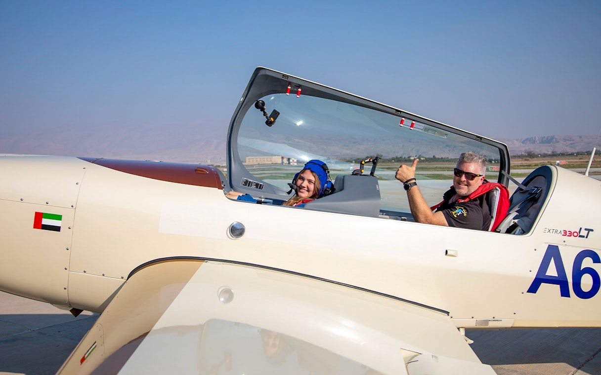 Pilot and passenger in aerobatic plane ready for takeoff, GFORCE Aerobatic Experience, UAE.