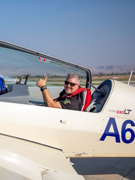 Pilot and passenger in aerobatic plane ready for takeoff, GFORCE Aerobatic Experience, UAE.