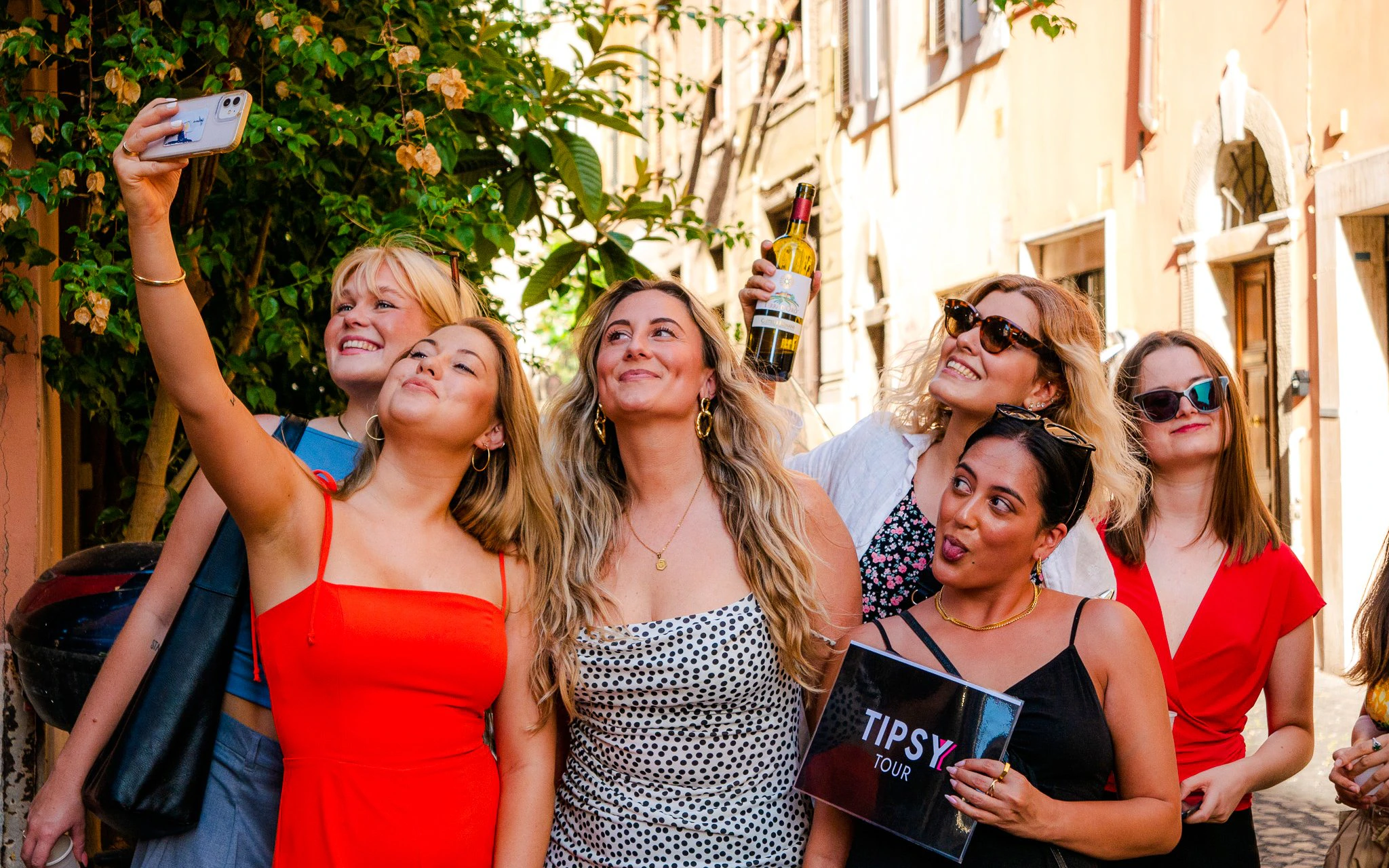 Guests enjoying the Tipsy Tour in Rome, taking a selfie on a charming street.