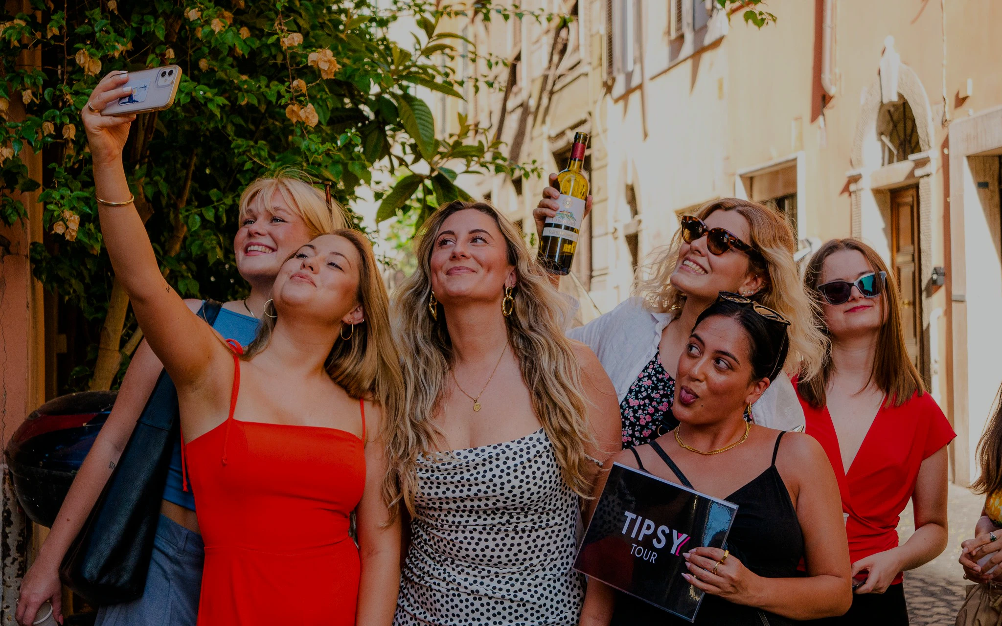 Guests enjoying the Tipsy Tour in Rome, taking a selfie on a charming street.