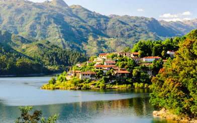 Peneda-Geres National Park village by a lake with mountain backdrop, Porto hiking tour.