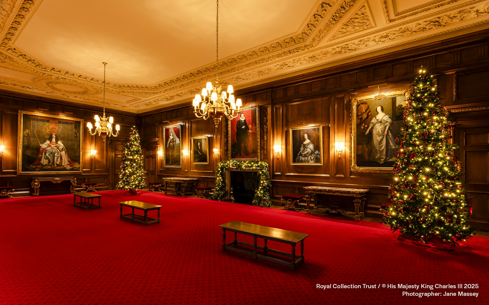 Palace of Holyroodhouse grand room with Christmas trees and portraits.
