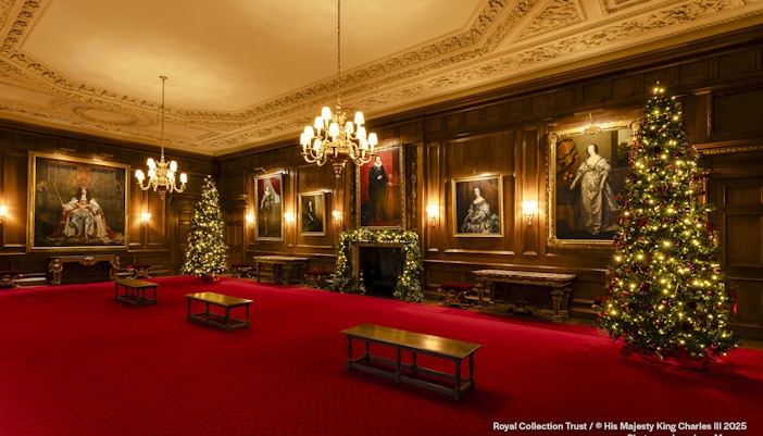 Palace of Holyroodhouse grand room with Christmas trees and portraits.