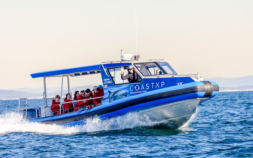 Boat with people on a whale watching tour in Lake Macquarie, Australia.