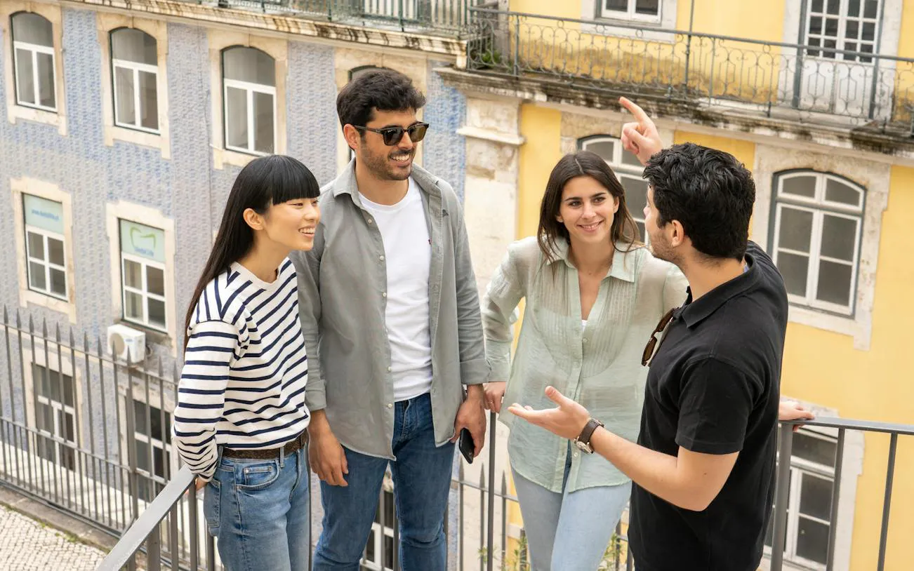Group of tourists enjoying a guided walking tour in Lisbon's historic center.