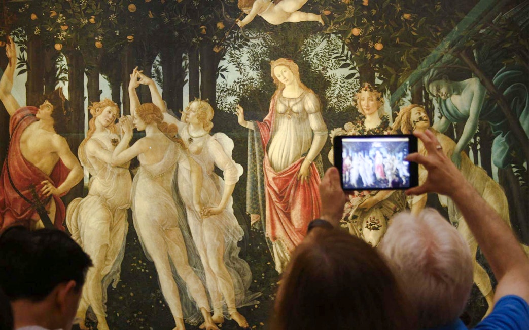 Visitors photographing Botticelli's "Primavera" at Uffizi Gallery during a private tour.