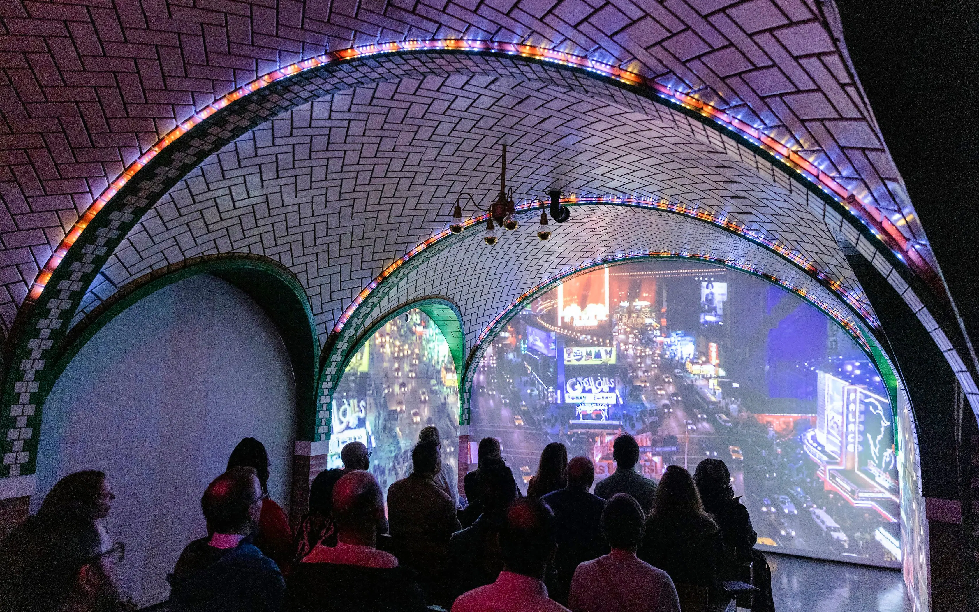 Guests viewing immersive cityscape exhibit inside RiseNY.