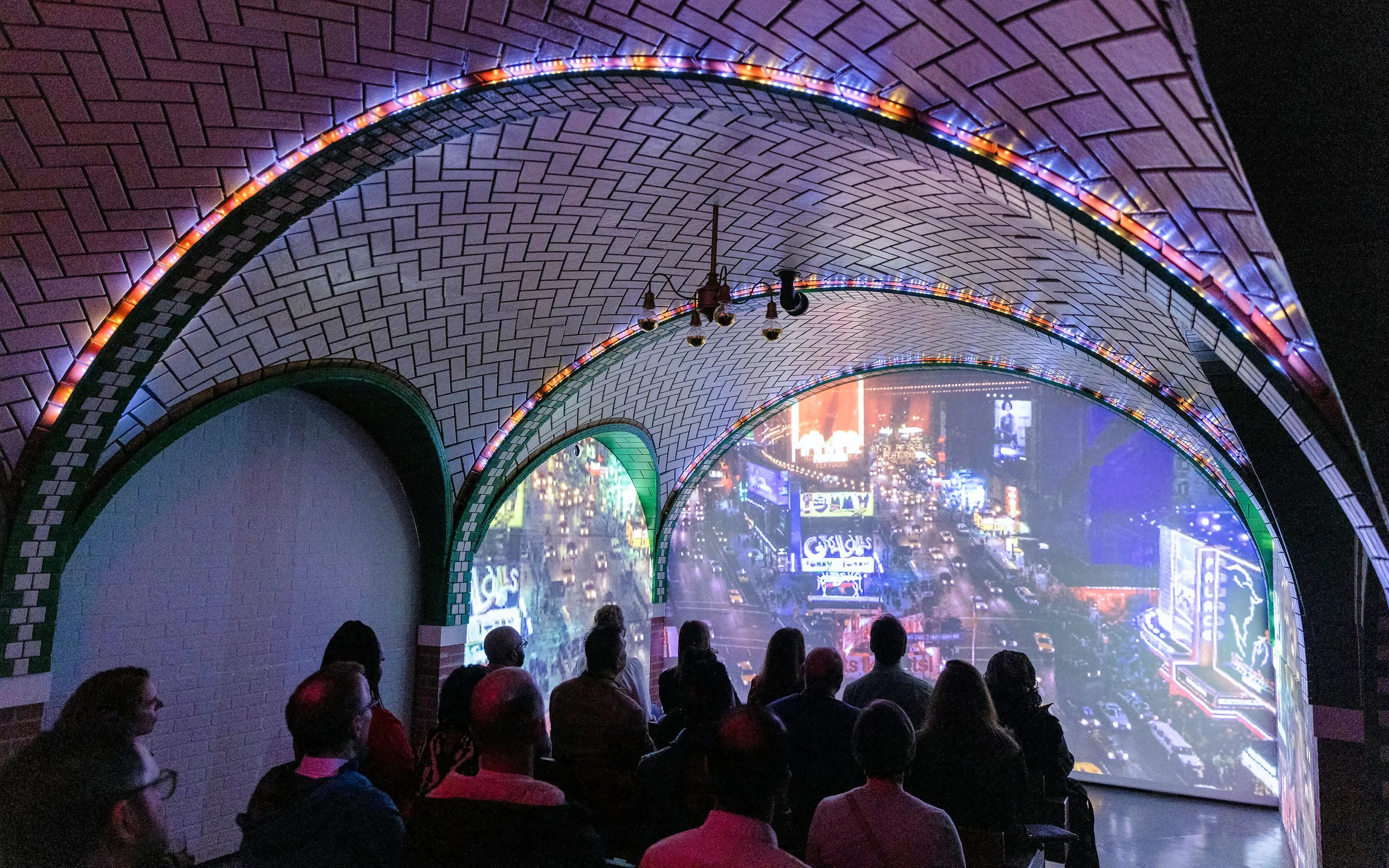 Guests viewing immersive cityscape exhibit inside RiseNY.