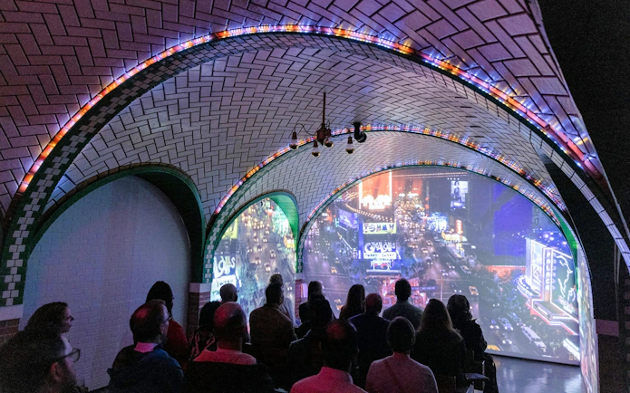 Guests viewing immersive cityscape exhibit inside RiseNY.
