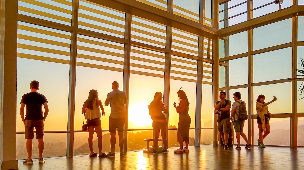 Visitors enjoying sunset views from Sky Costanera in Santiago, Chile.