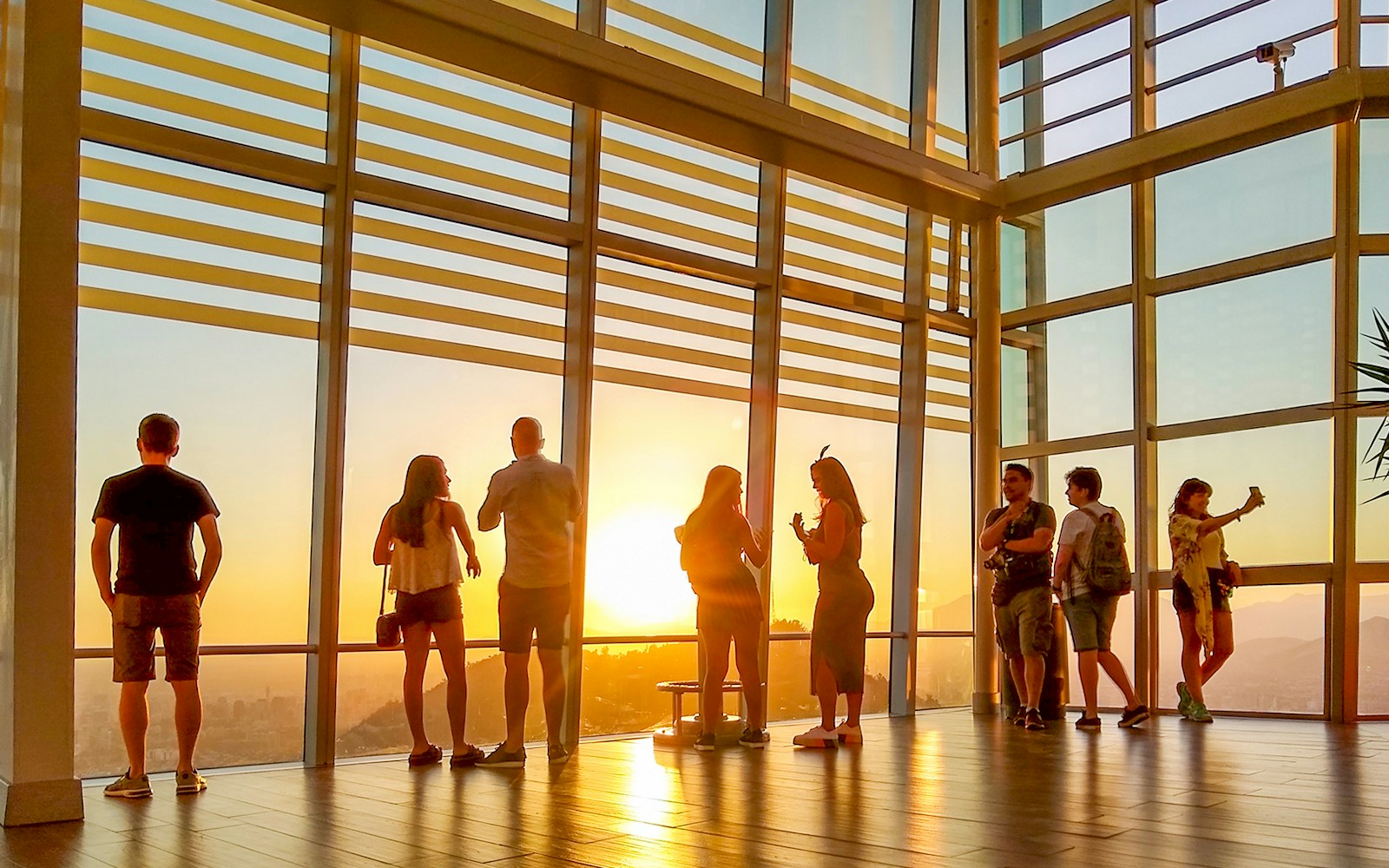 Visitors enjoying sunset views from Sky Costanera in Santiago, Chile.