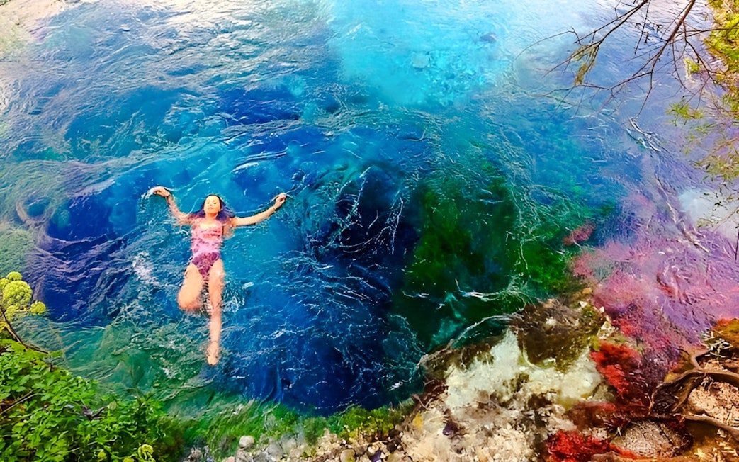 Guest swimming in the vibrant waters of the Blue Eye, Albania.