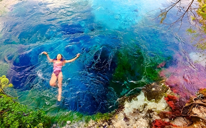 Guest swimming in the vibrant waters of the Blue Eye, Albania.