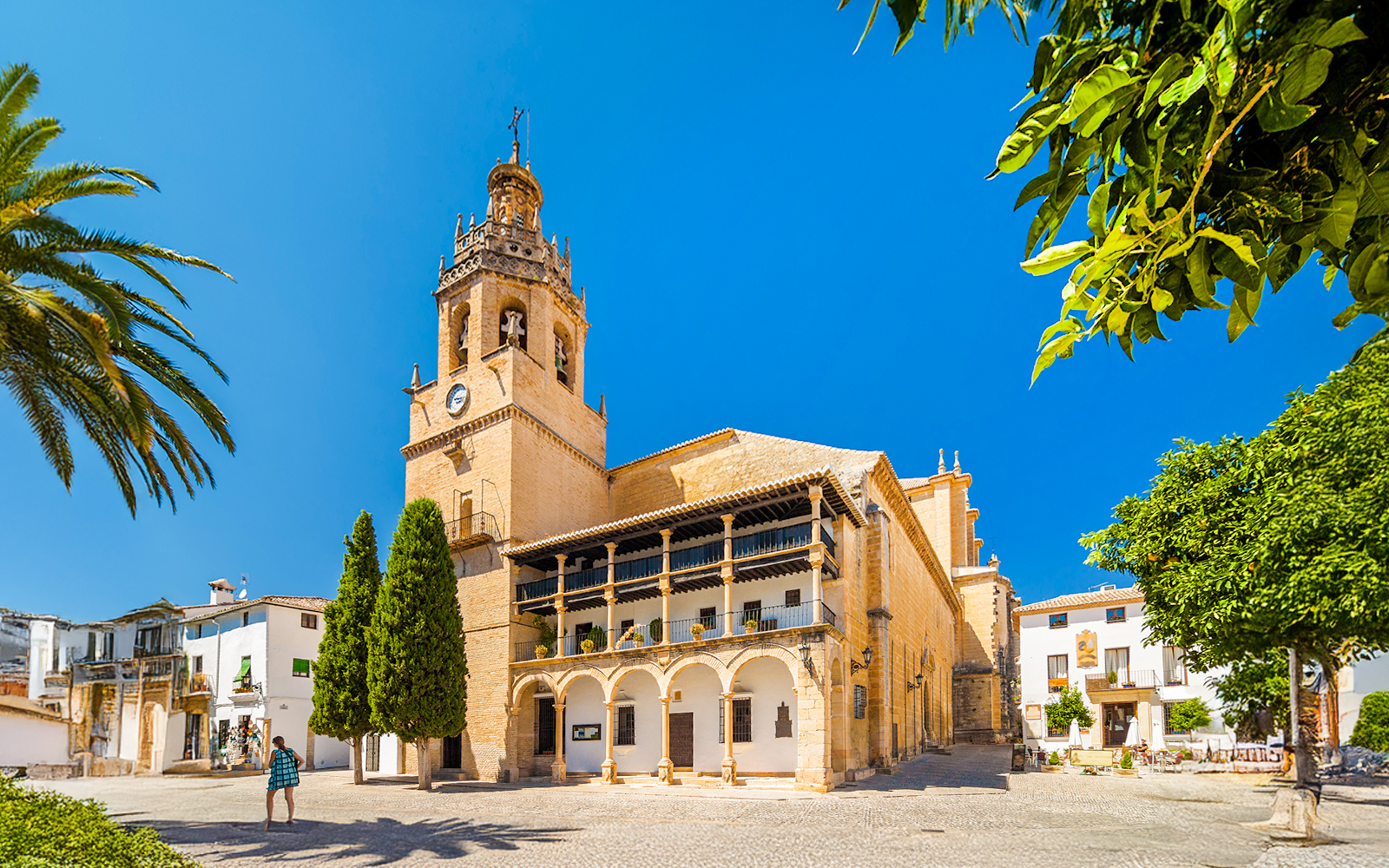 Church Santa Maria La Mayor in Ronda, Andalusia, with bell tower and courtyard.