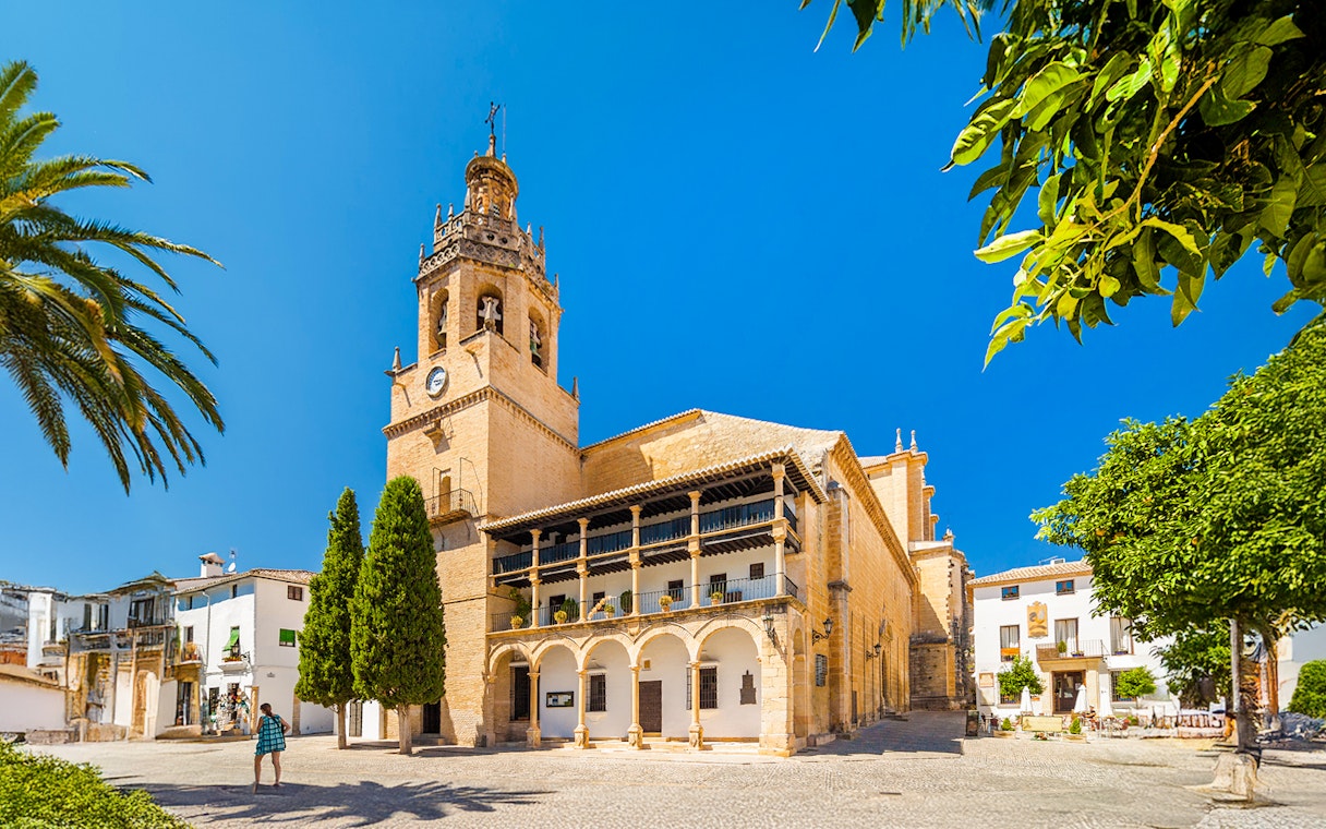 Church Santa Maria La Mayor in Ronda, Andalusia, with bell tower and courtyard.